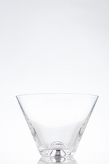 Triangle clear cocktail glass on a white background