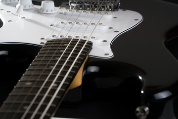 Detail of strings, volume and tone of electric guitar