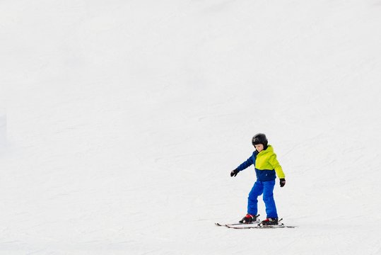 Happy little child skiing.