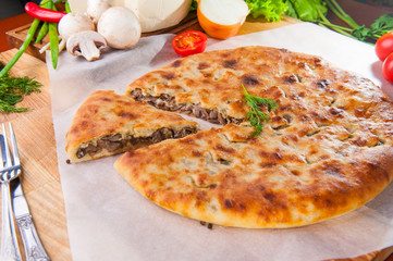 Selective Focus Traditional vegetable closed pie on the table. Composition of ingridients.