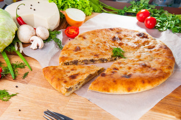 Selective Focus Traditional vegetable closed pie on the table. Composition of ingridients.