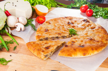 Selective Focus Traditional vegetable closed pie on the table. Composition of ingridients.