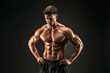 bodybuilder posing. Beautiful sporty guy male power. Fitness muscled man