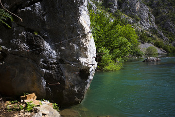 Hikers cable in Krupa river canyon in Croatia