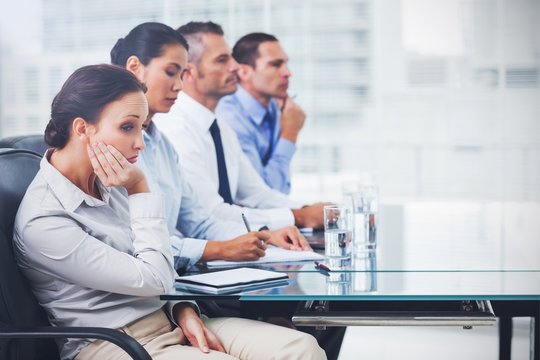 Businesswoman getting bored while attending presentation