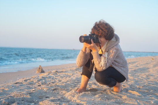 Female photographer on the beach