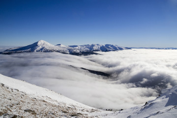 Panorama of winter mountain ridge on a background of blue sky. S