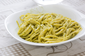 a portion of fresh italian spaghetti al pesto