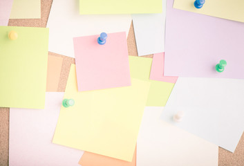 Empty blank sticky notes on notice board in office. Background or backdrop for business information. Concept image of communication or reminder with copy space.