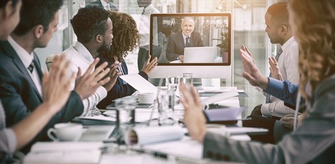 Business people looking at screen during video conference