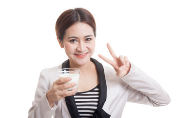 Healthy Asian woman drinking a glass of milk show victory sign.