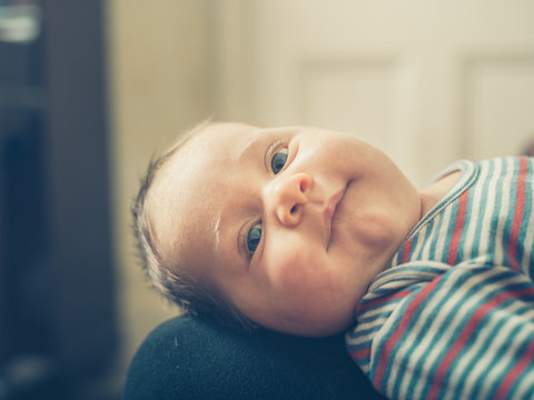 Happy baby on lap of mother