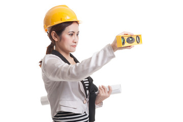 Asian engineer woman with blueprints and level.
