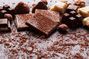 Variety of sweet homemade chocolate pralines on wooden background