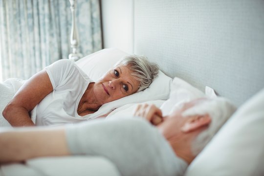 Senior couple relaxing on bed