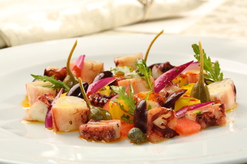 Fine dining restaurant dish seafood salad, octopus, capers, olives