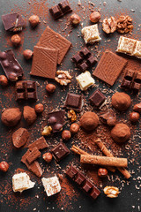 Variety of sweet homemade chocolate pralines on wooden background