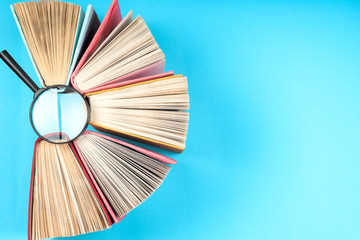 Top view of bright colorful hardback books in a circle.