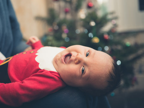 Baby in santa outfit at christmas