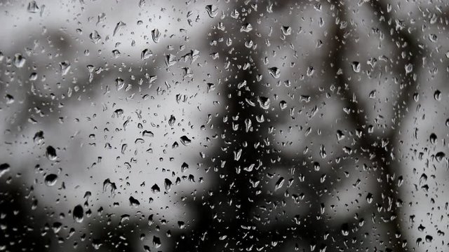 Drops of rain on the window glass with blurred background