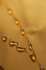 drops of honey on a golden background 1