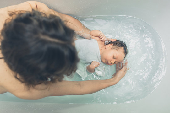 Baby in the bathtub with mother