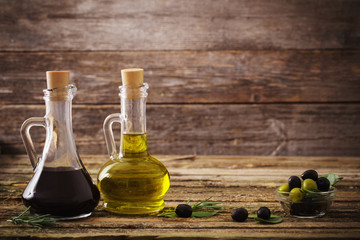 Fototapeta na wymiar olive oil and balsamic vinegar on a wooden background
