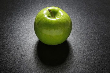 green apple on black background