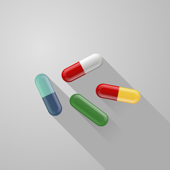 set of blue, red, white, green, yellow pills isolated on gray background with long shadow