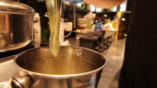 Breaking eggs in an industrial kitchen shot in slow motion