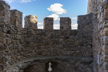 Stone walls of a medieval castle. Town of Consuegra in the provi