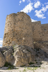 Naklejka premium Stone walls of a medieval castle. Town of Consuegra in the provi