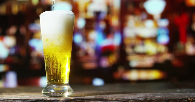 golden icy cold beer in extreme macro foam. clear beverage and bubbles of carbon dioxide. fresh beer of double-hop just poured. concept of fresh and thirst-quenching beer. texture and extreme macro 