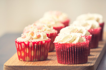 different cupcakes on wooden board