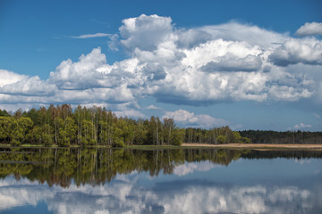 Landscape of sky with clouds pond Beautiful white billowing  against a blue .
