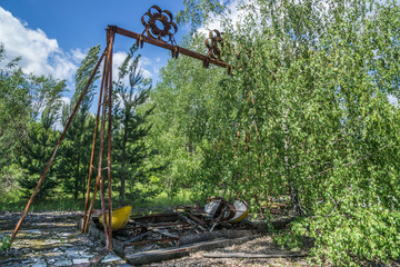 abandoned swing boat in amusement park in pripyat, chernobyl area