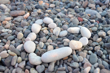 Grey stones in shape of heart, evening beach, love concept