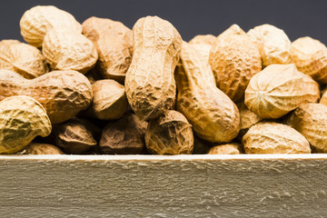 Peanuts in shell with black background texture