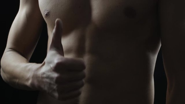 sports guy holding his hand over his stomach. Training Sit Ups