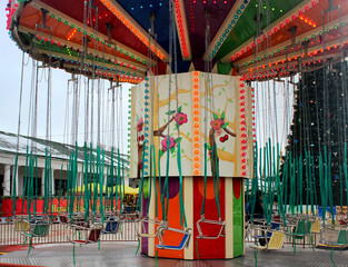 Children's bright carousel chain in the center of the square close-up in the winter season