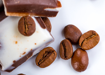 Cup of coffee and beans with delicious macaroon on a white backg