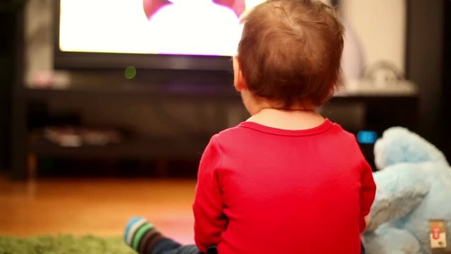 Little boy watching television in home
