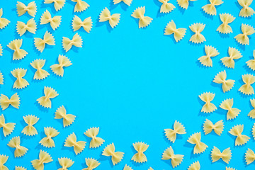 Frame from wheat pasta on blue background