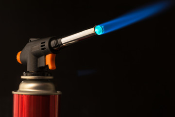 gas burner - the tool is lit a blue flame