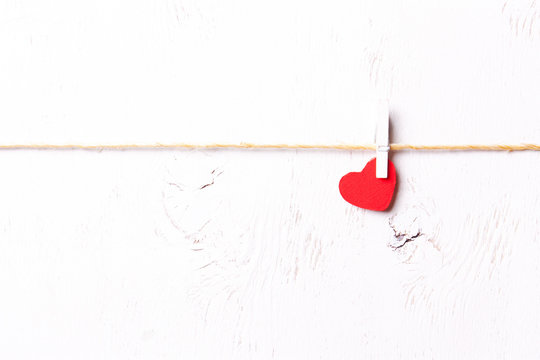 Red wooden heart on a white background