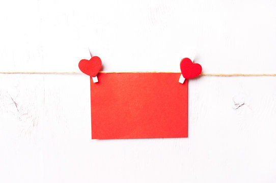 two red wooden heart hold leaf