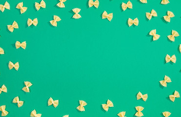 Frame from wheat pasta on green background