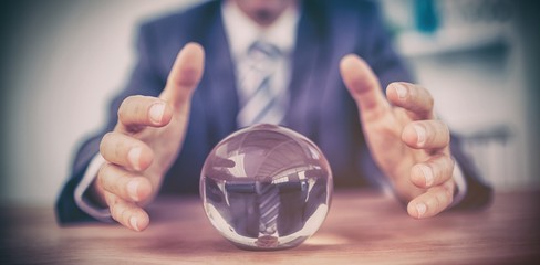 Businessman forecasting a crystal ball - Powered by Adobe