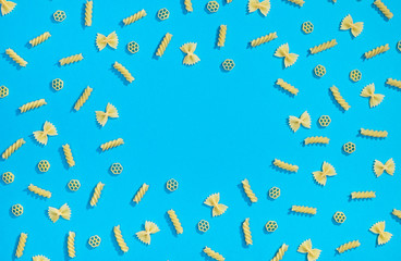 Frame from wheat pasta on blue background