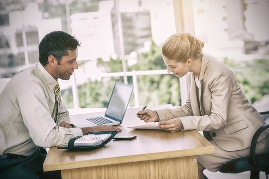 Businesswoman signing contract at interview